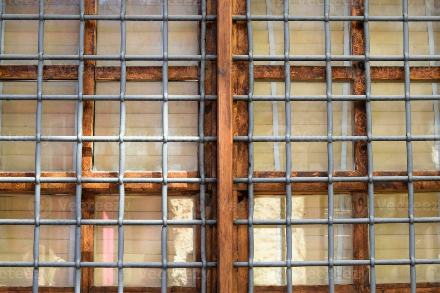 Metal bars in front of the window frame. photo