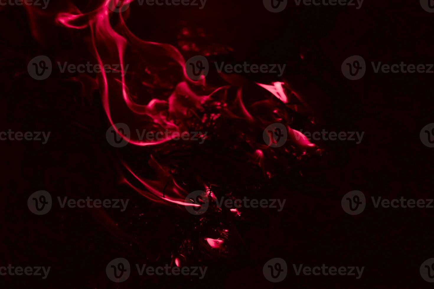A dark red flame. Burning of rice straw at night. photo