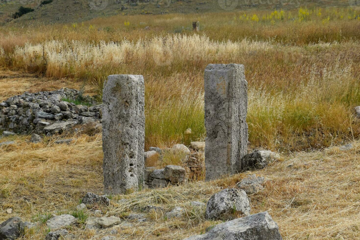 Fragments of ancient buildings, ruins of the ancient city of Hierapolis. Stone blocks with traces of stone machining. photo