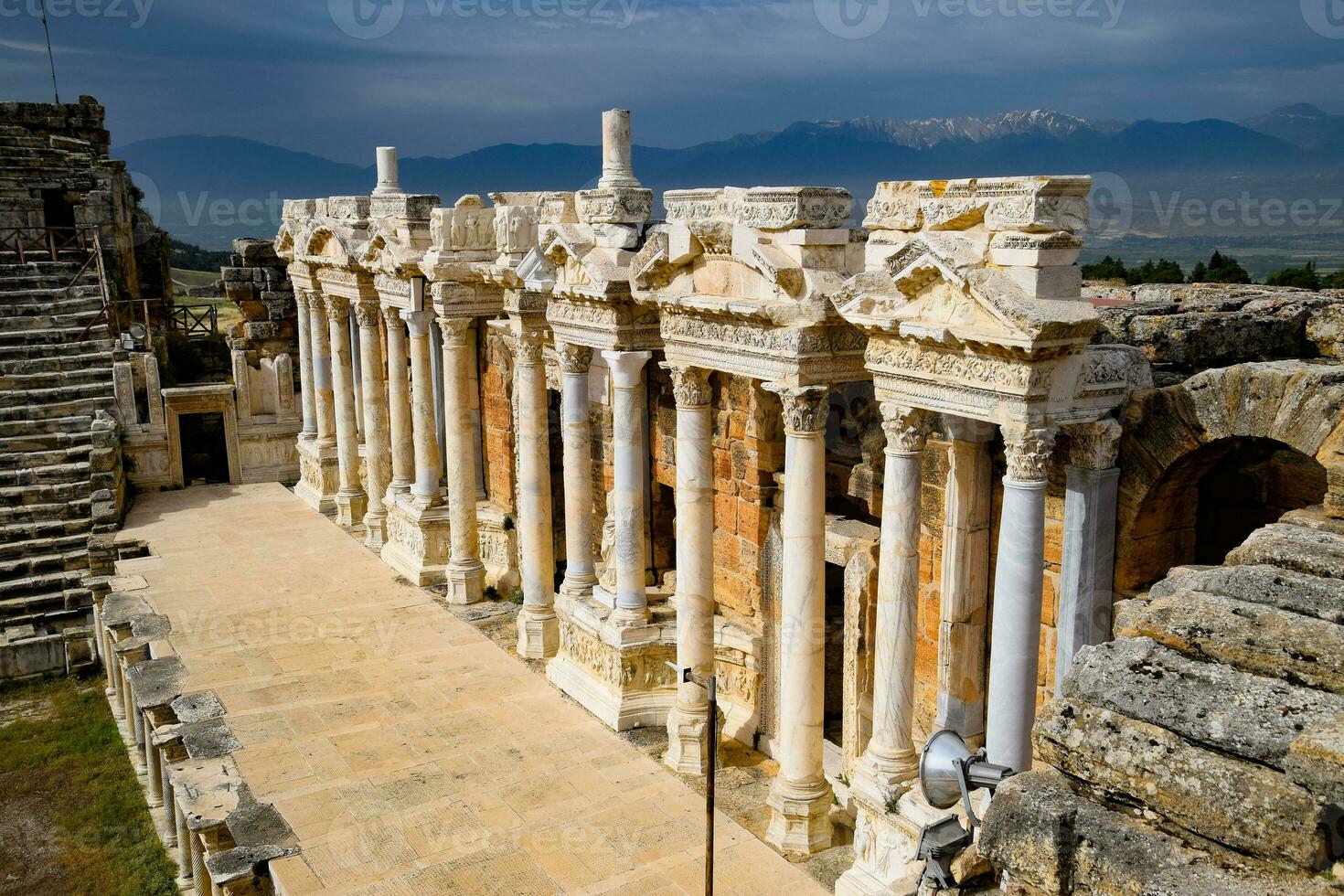 Columns on the stage of the amphitheater. Ancient antique amphitheater in city of Hierapolis in Turkey. photo