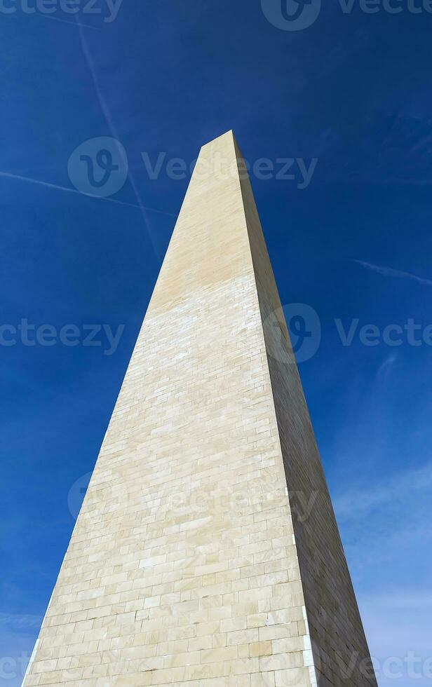 Low angle view of the Washington Monument under clear blue sky in Washington, D.C. photo