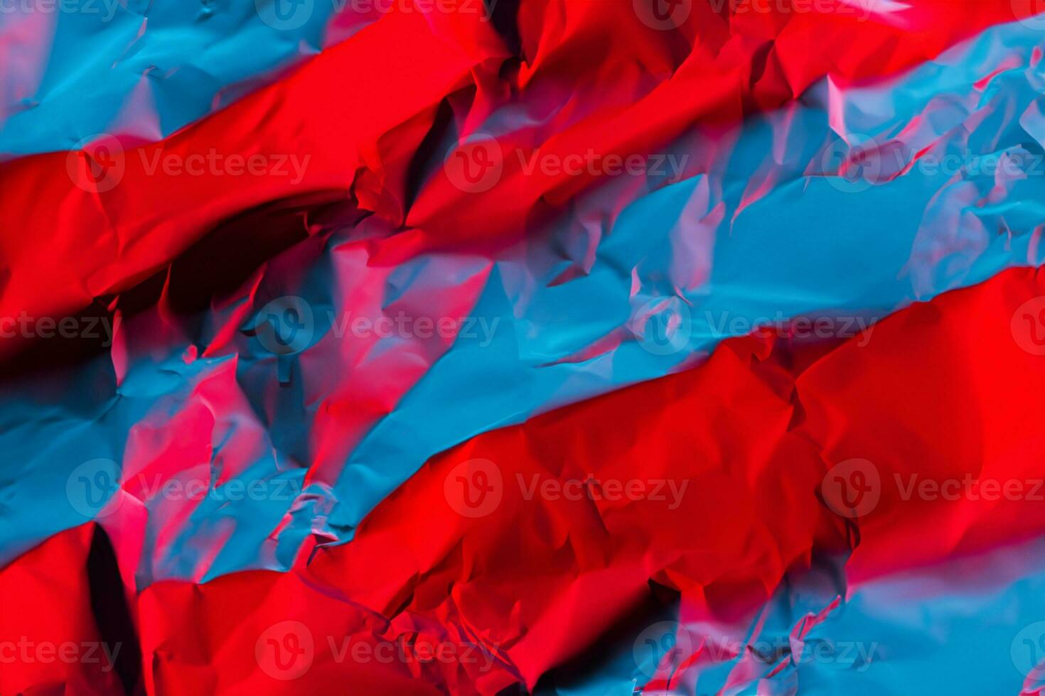 Crushed paper background in vibrant bold gradient holographic neon colors. Fire background imitation. Flat lay. Top view. photo