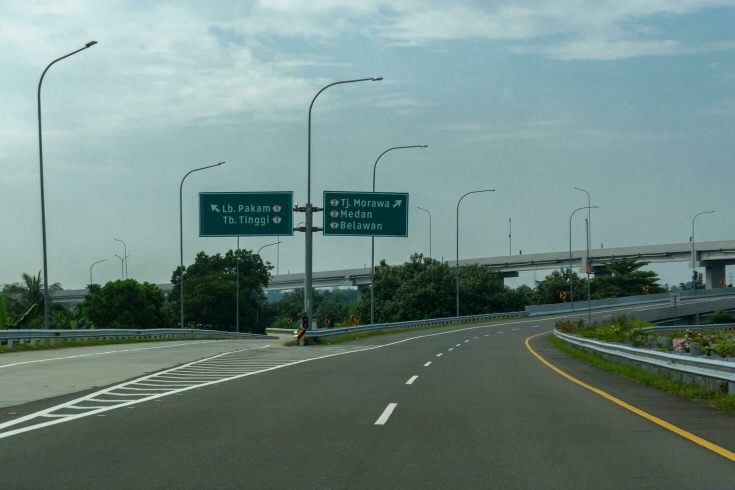 Diretion sign in North Sumatera highway. view of Jalan Tol Trans Sumatera Trans Sumatera Toll Road in Medan, North Sumatera. photo