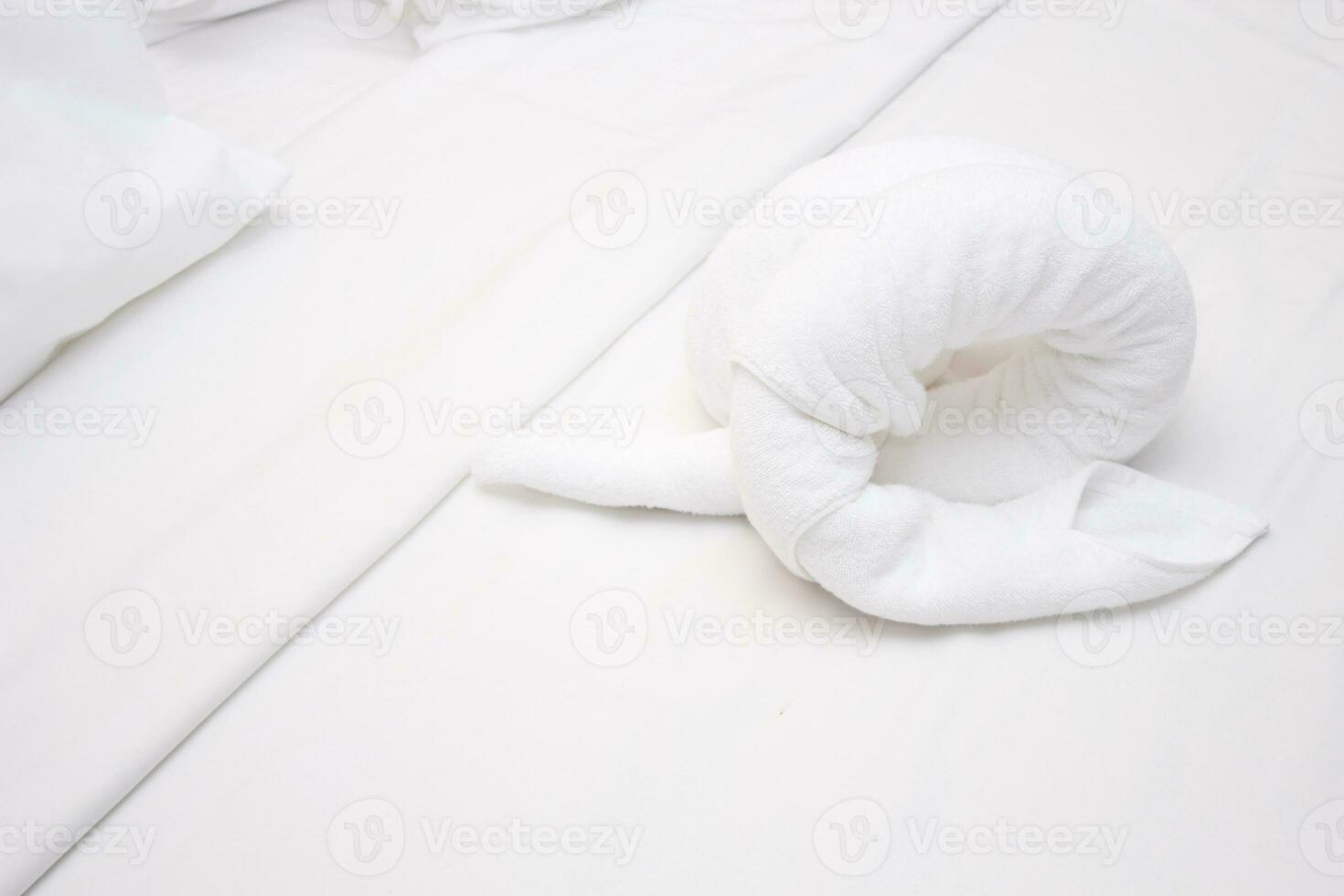 White towels on the bed in the hotel room rolled up in the shape of animals, hotel room, white bed in the hotel photo