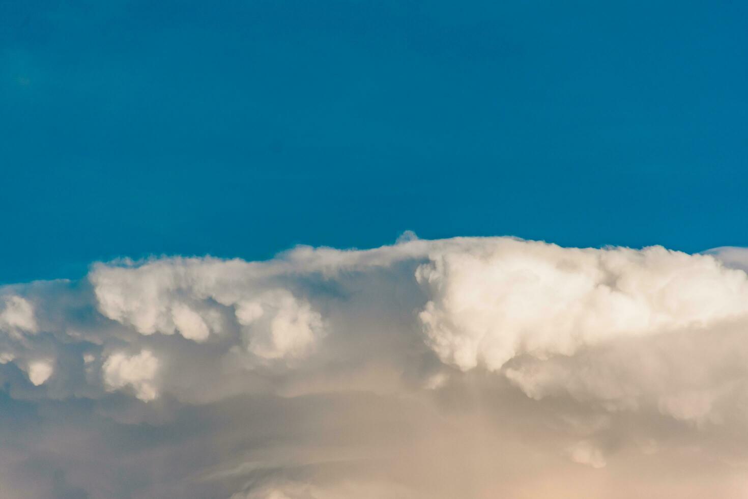 various shapes of clouds on different levels of blue background photo