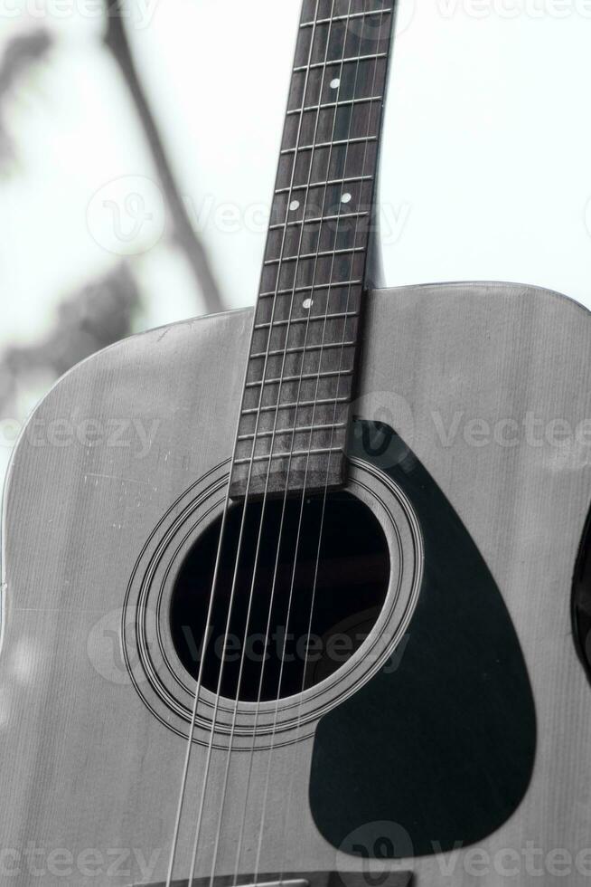 black and white acoustic guitar portrait. music poster background photo