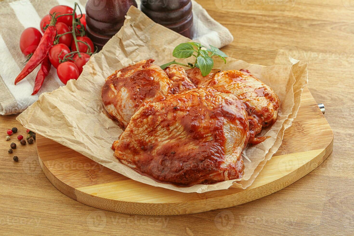 Marinated chicken leg in tomato sauce photo