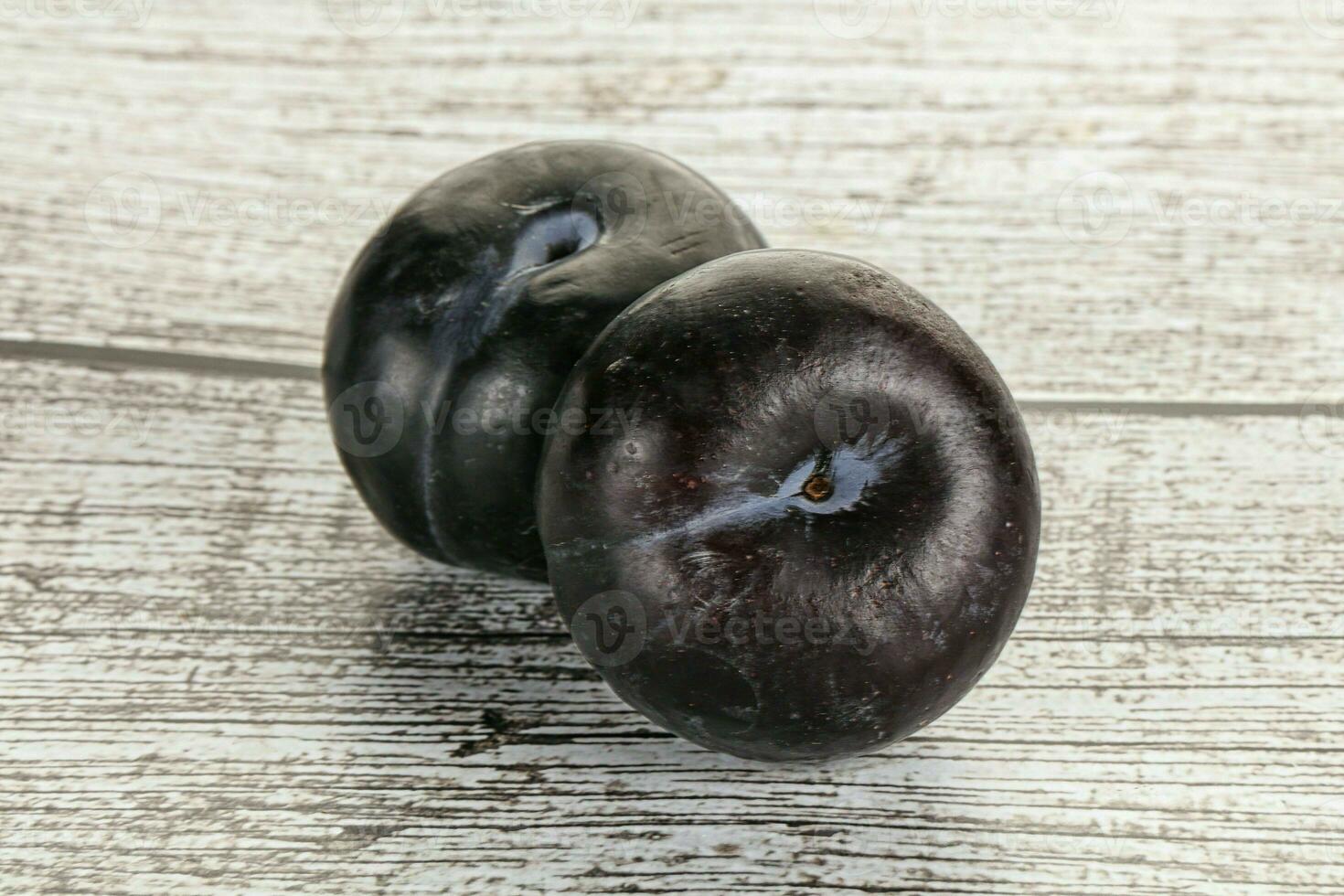 Two ripe sweet black plums photo