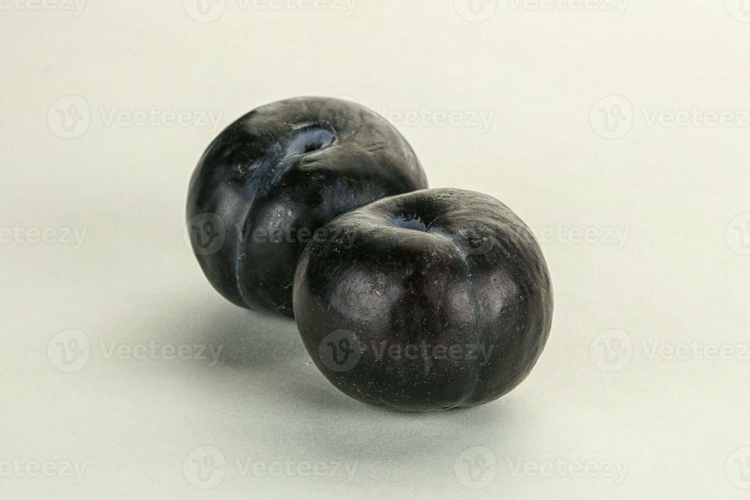 Two ripe sweet black plums photo