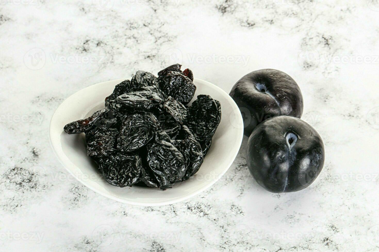 Dry prunes in thw bowl photo