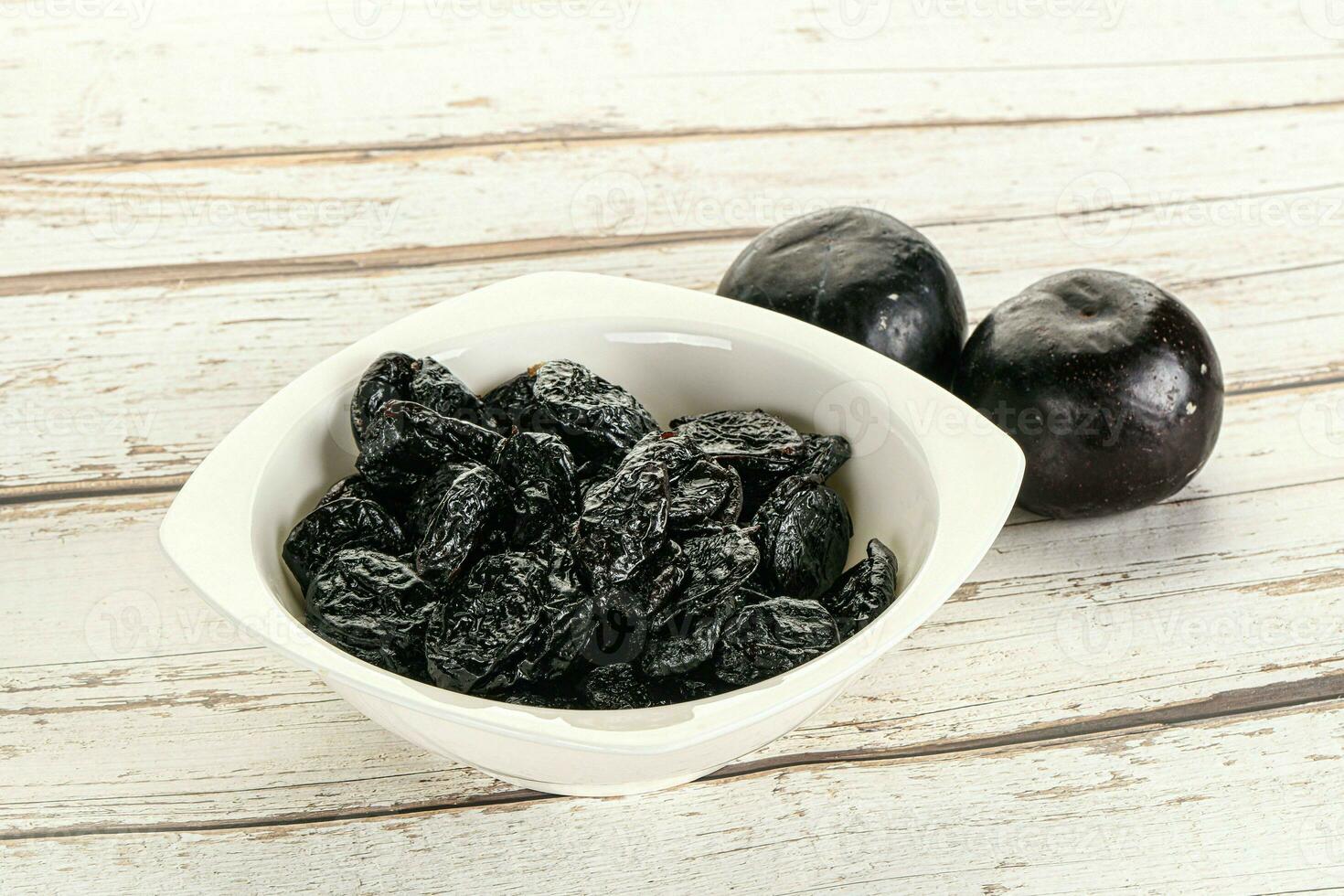 Dry prunes in thw bowl photo