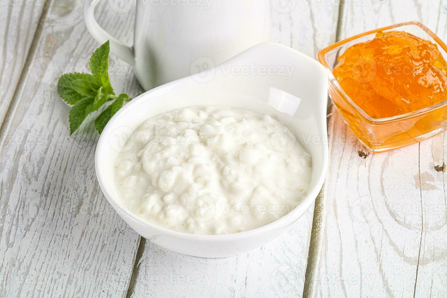 Grain curd with cream and jam photo