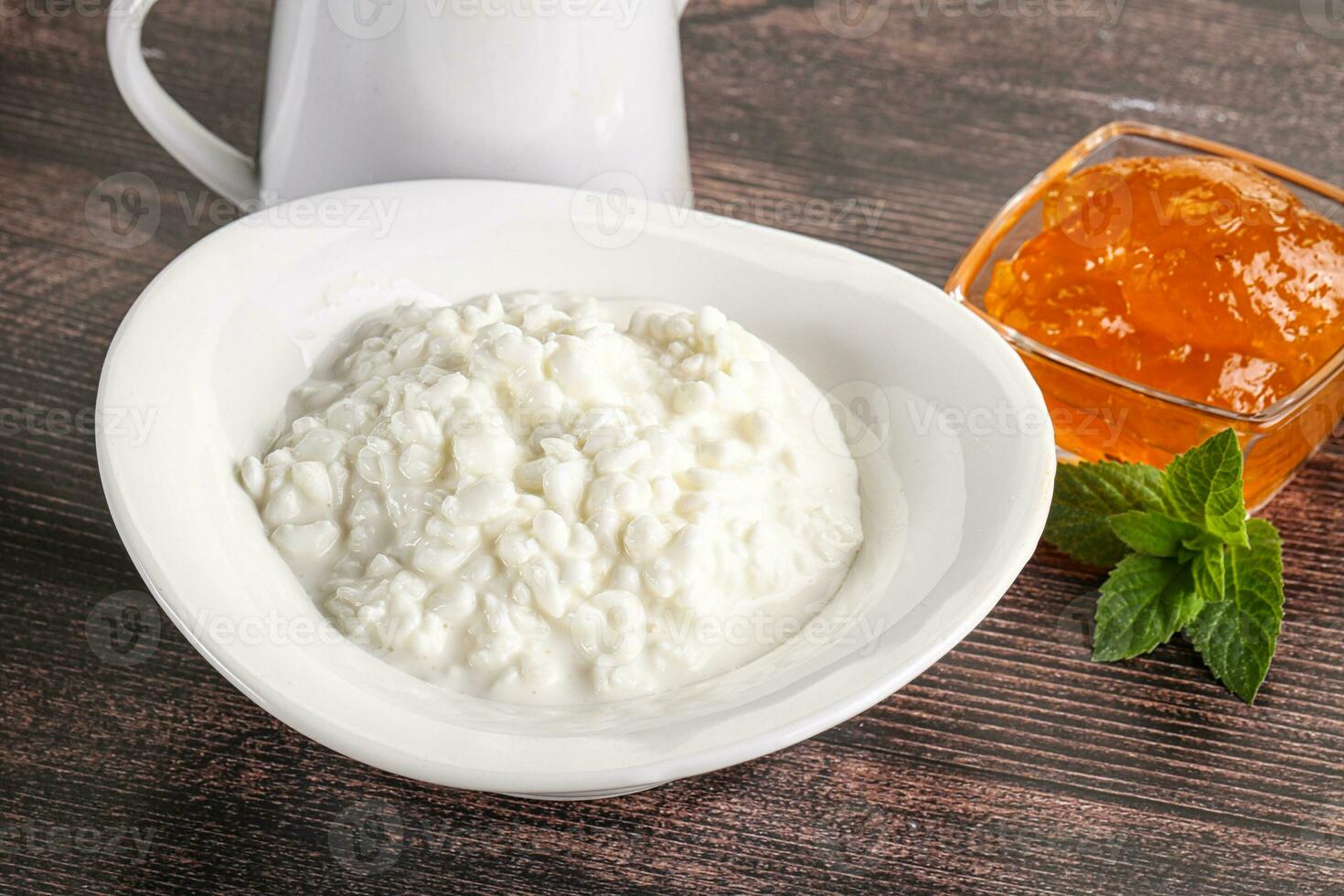 Grain curd with cream and jam photo