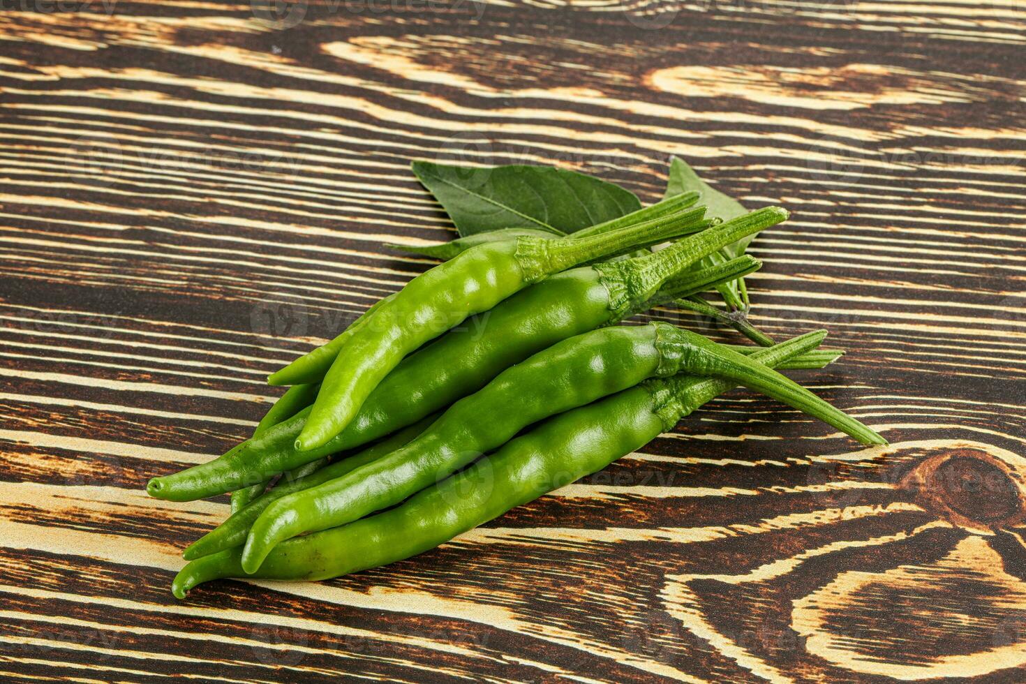 Spicy green chili pepper heap photo