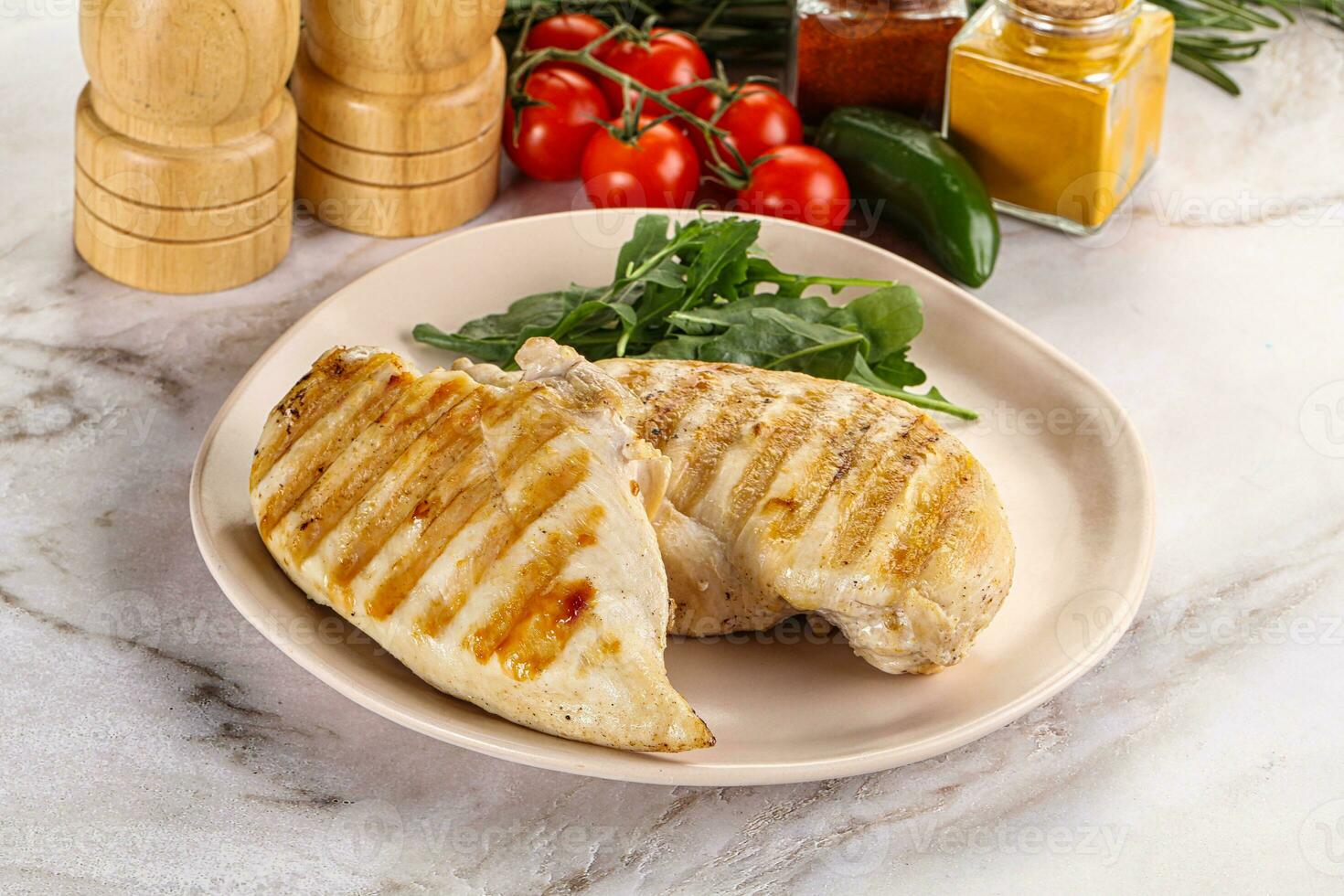 Grilled chicken breast served arugula photo
