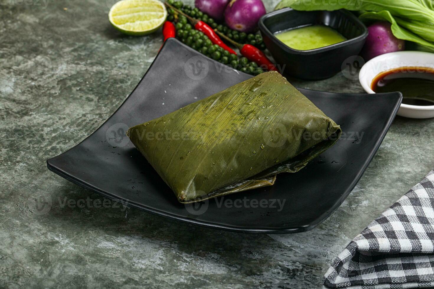 Asian cuisine - rice with filling in banana leaf photo