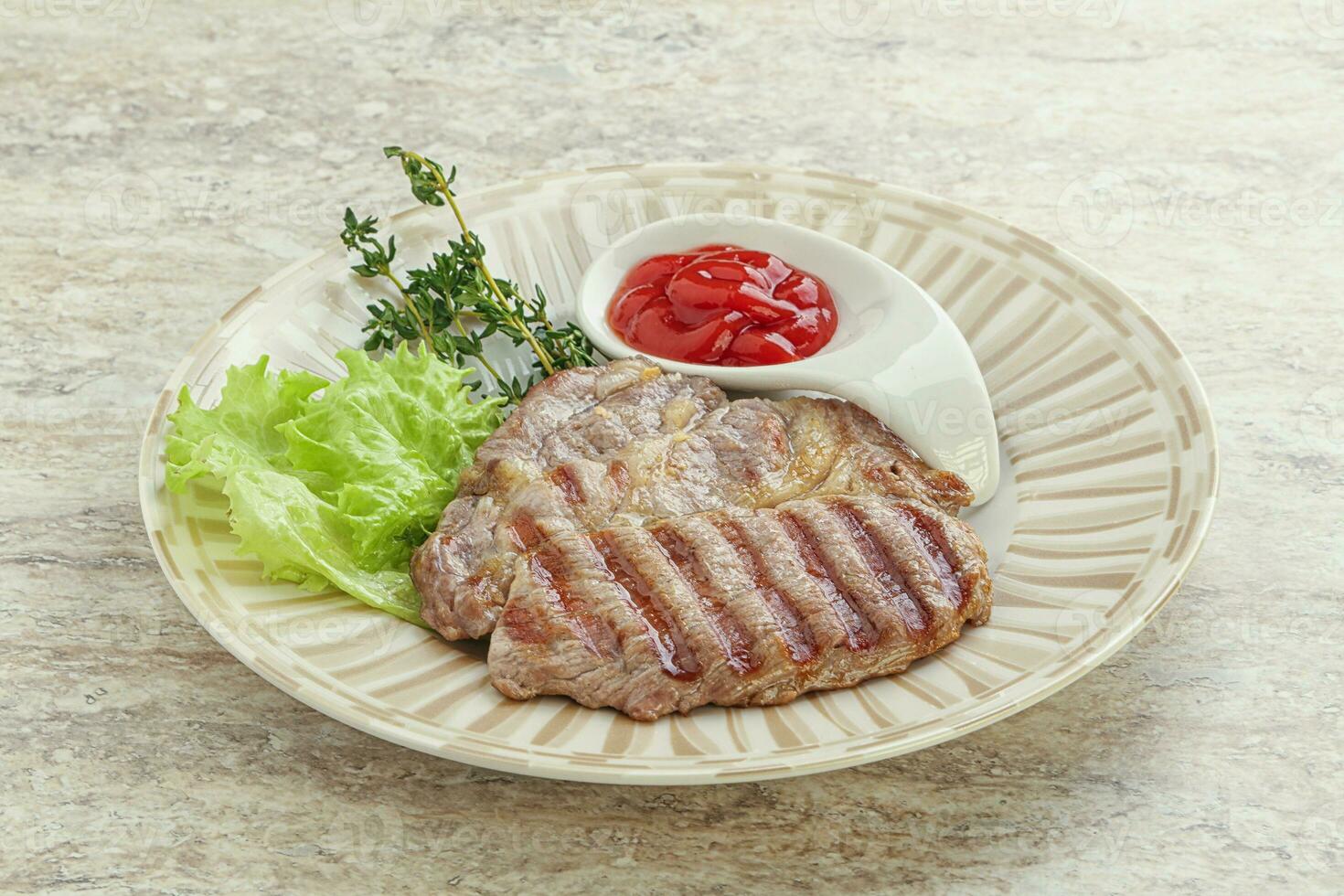 Grilled pork neck steak with ketchup photo