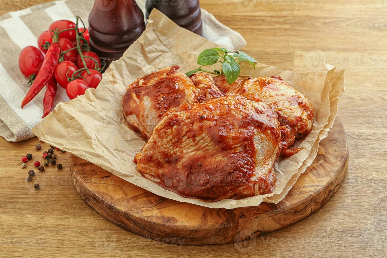 Marinated chicken leg in tomato sauce photo