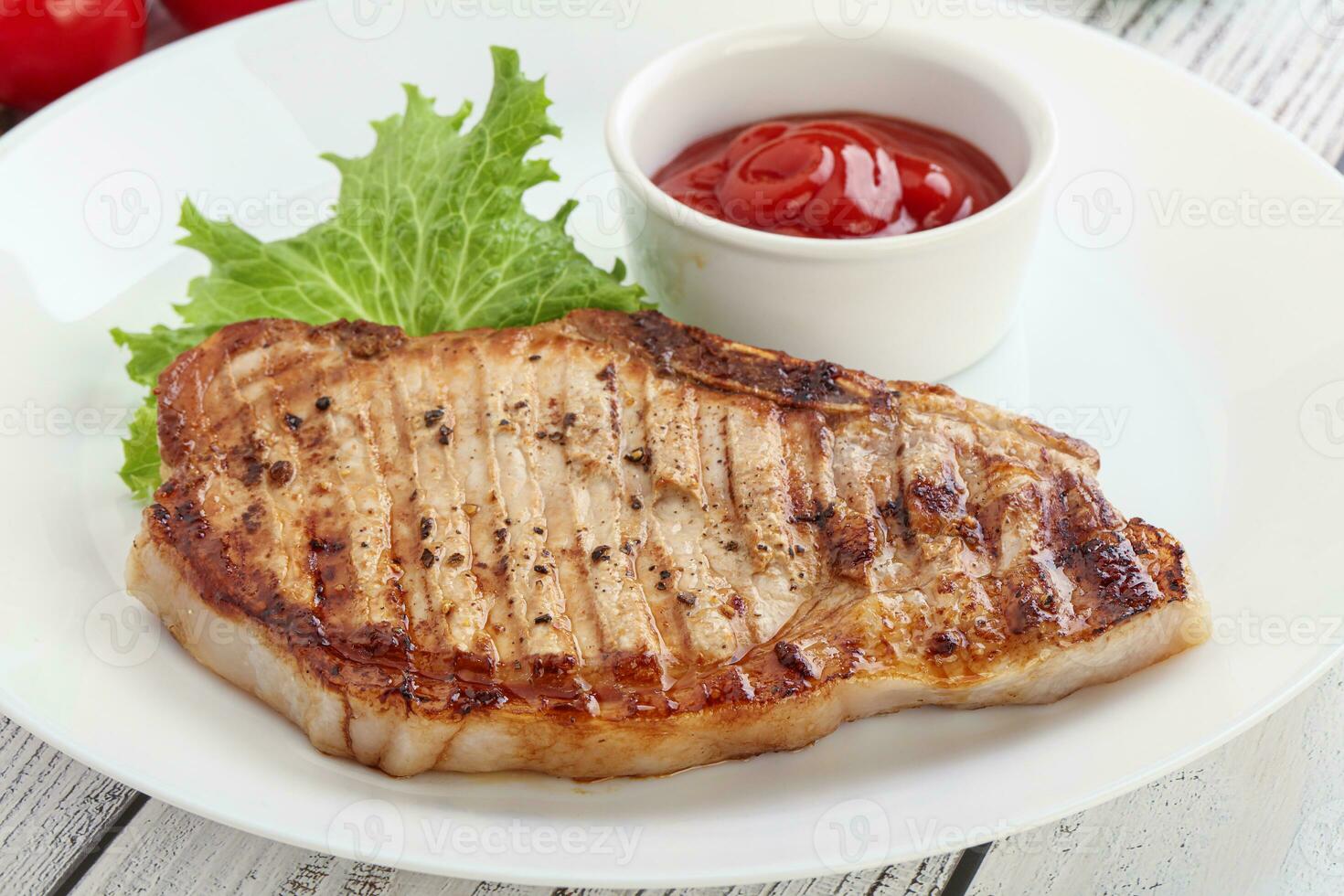 Grilled pork steak with ketchup photo