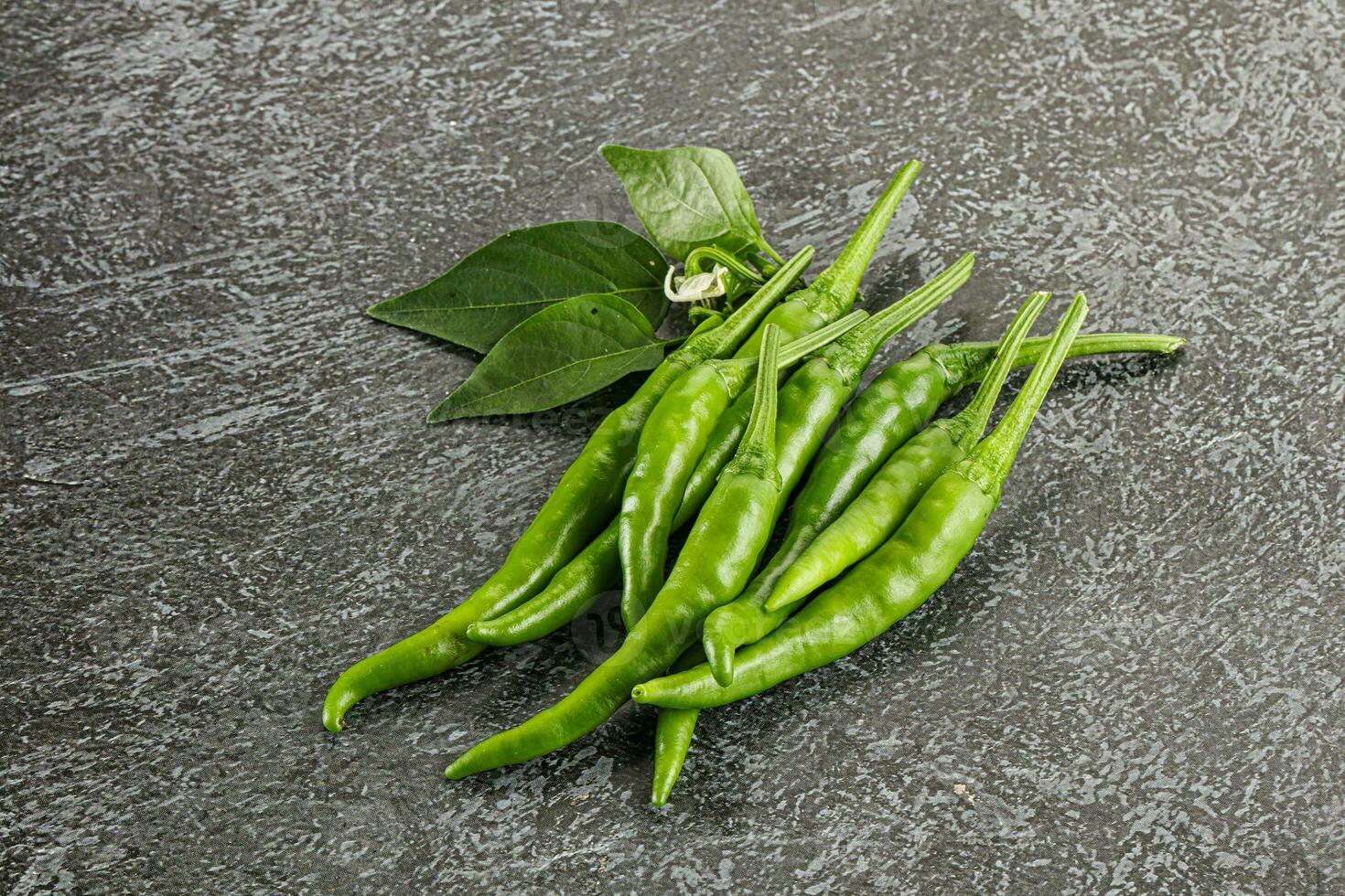 Spicy green chili pepper heap photo