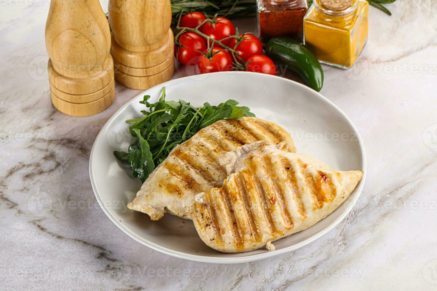 Grilled chicken breast served arugula photo