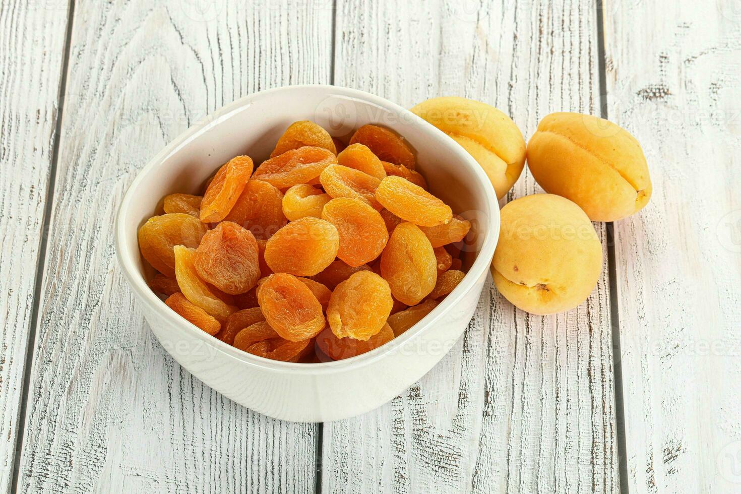 Dried apricot heap in the bowl photo