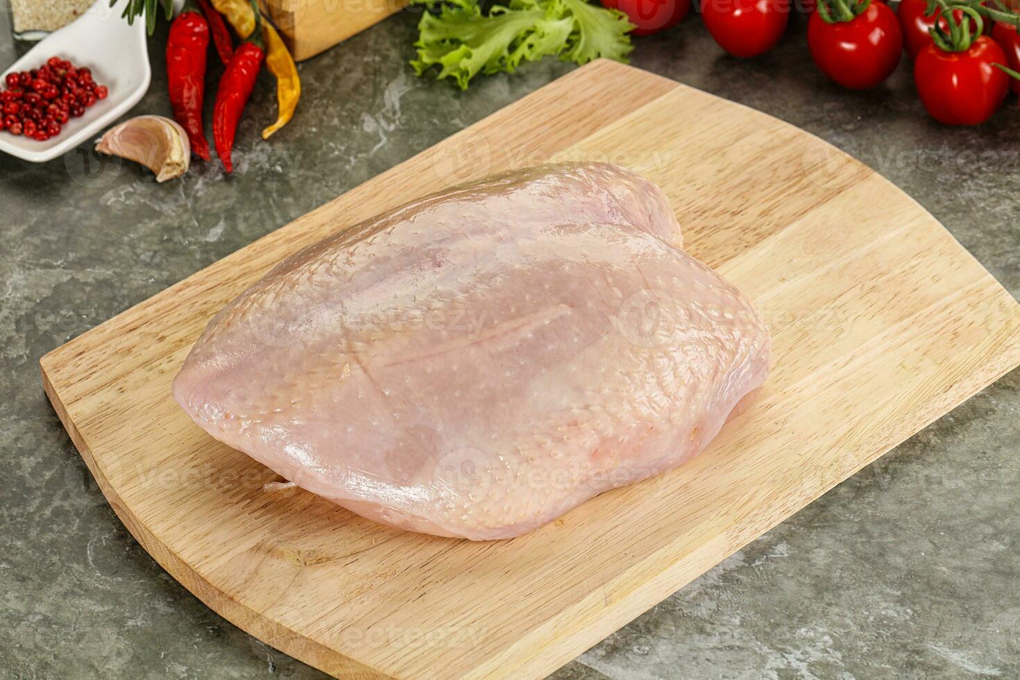 Raw chicken breast with skin photo