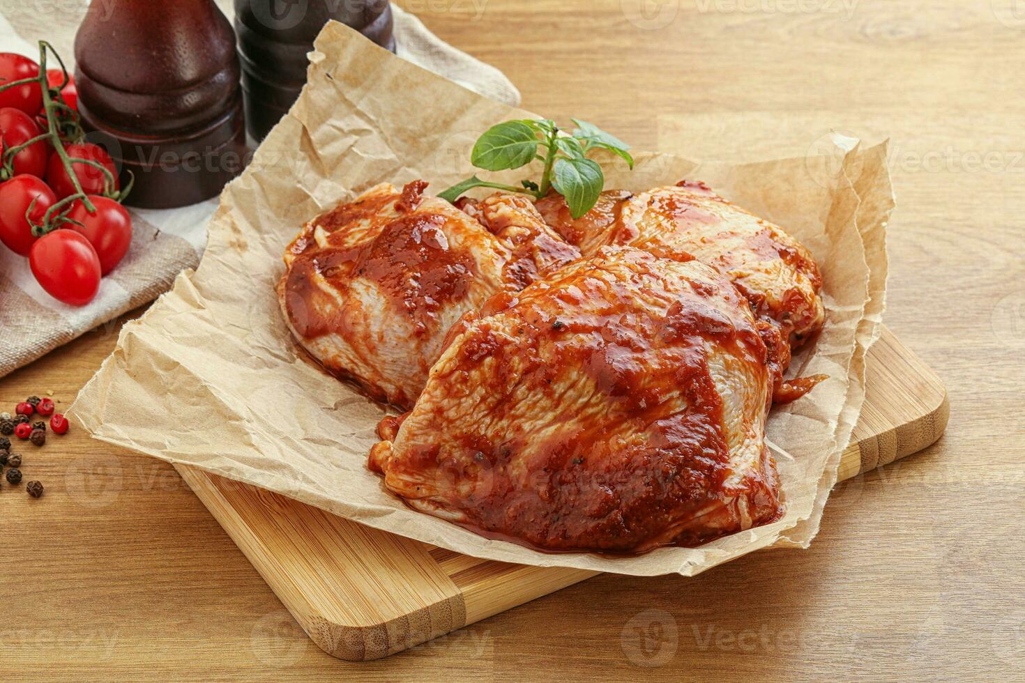 Marinated chicken leg in tomato sauce photo