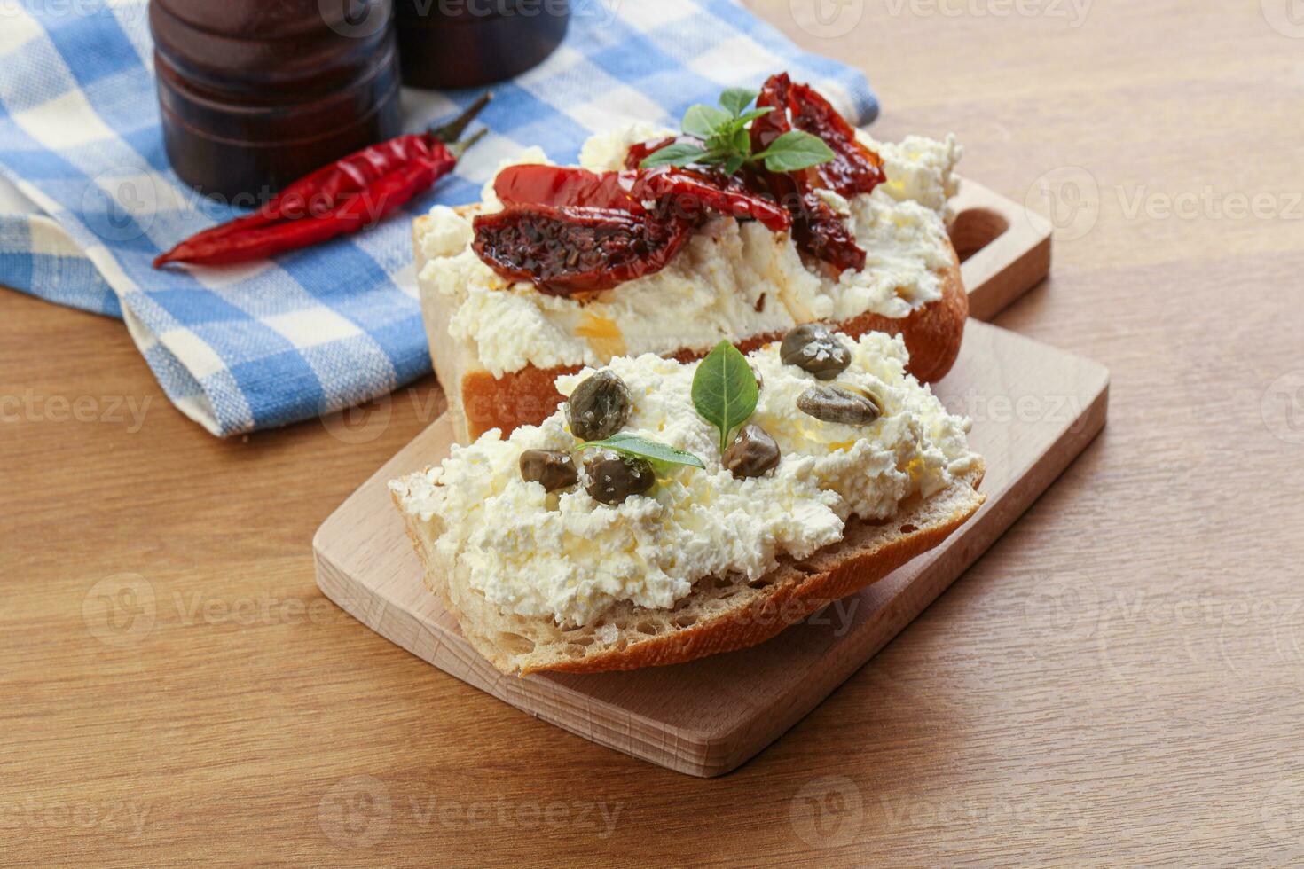 bruschetta with soft cheese capers and tomato photo