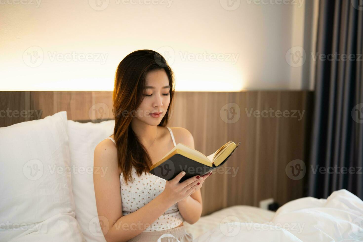 asiático mujer haciendo manos juntos en oración a Dios a lo largo con el Biblia en el cristiano concepto de fe, espiritualidad y religión, mujer orar en el Biblia. oración Biblia en el cama en el dormitorio. foto