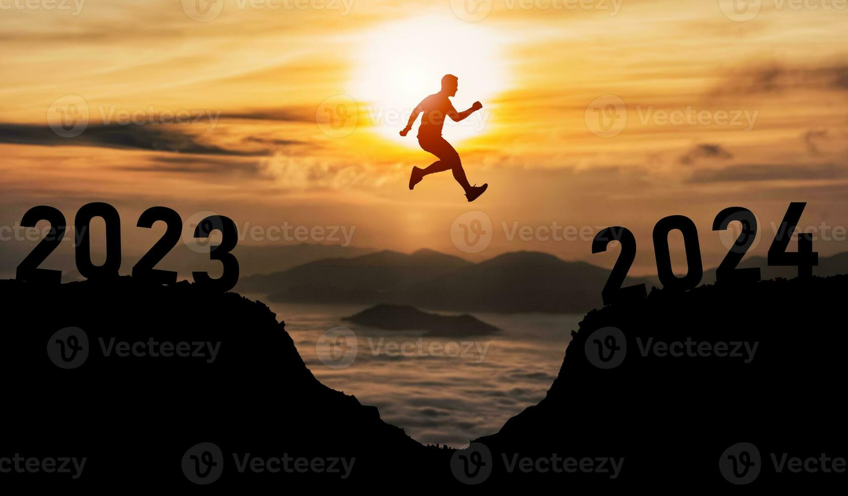 Man jump happy new year 2024 concept, silhouette of man jumping over barrier cliff and success from 2023 cliff to 2024 cliff with sunset background. Happy New Year for web banner and advertisement. photo