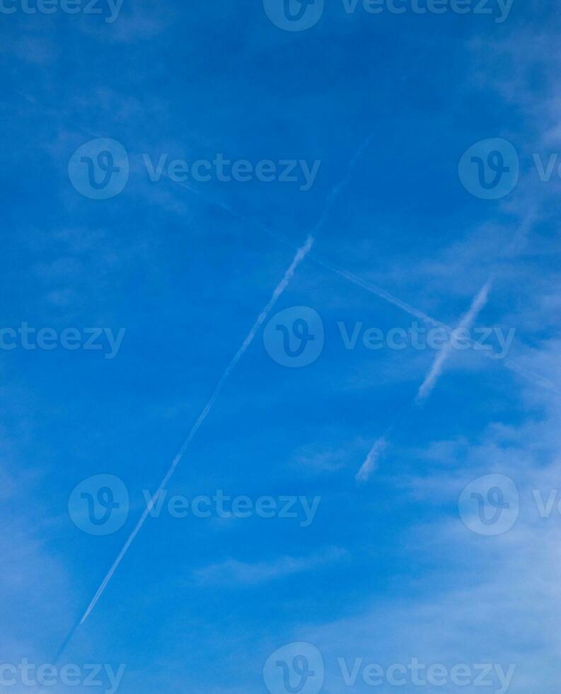 Condensation trail of passenger aircraft in form of a lattice in the sky. photo