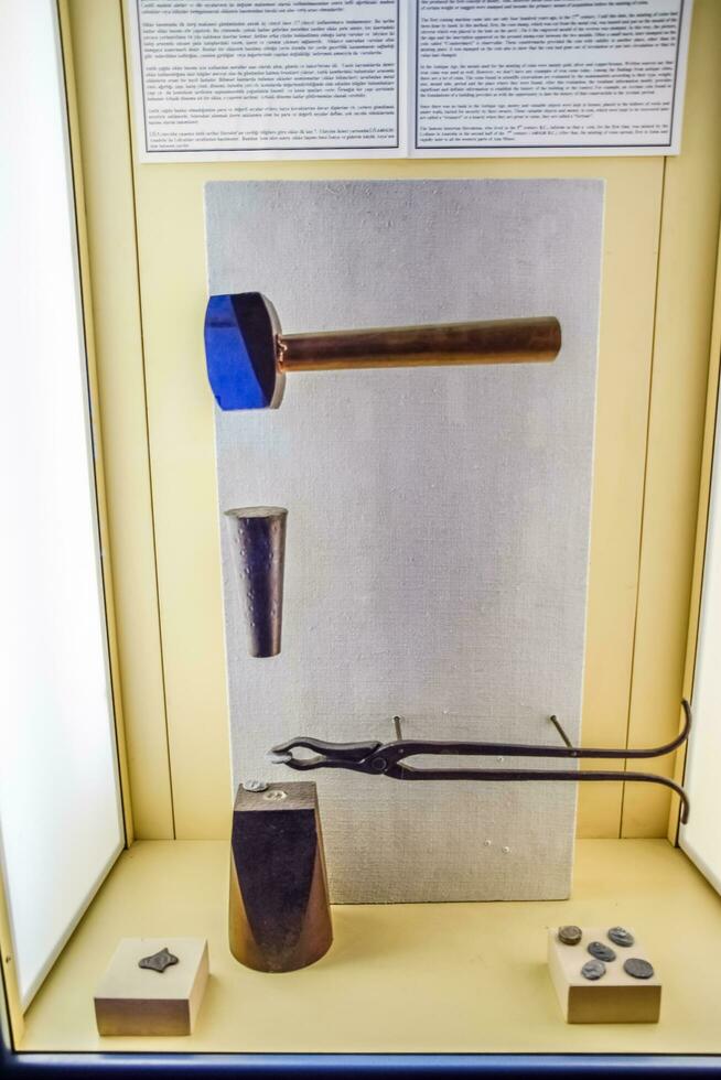 Tools for minting coins. Anvil and vice, making coins. photo