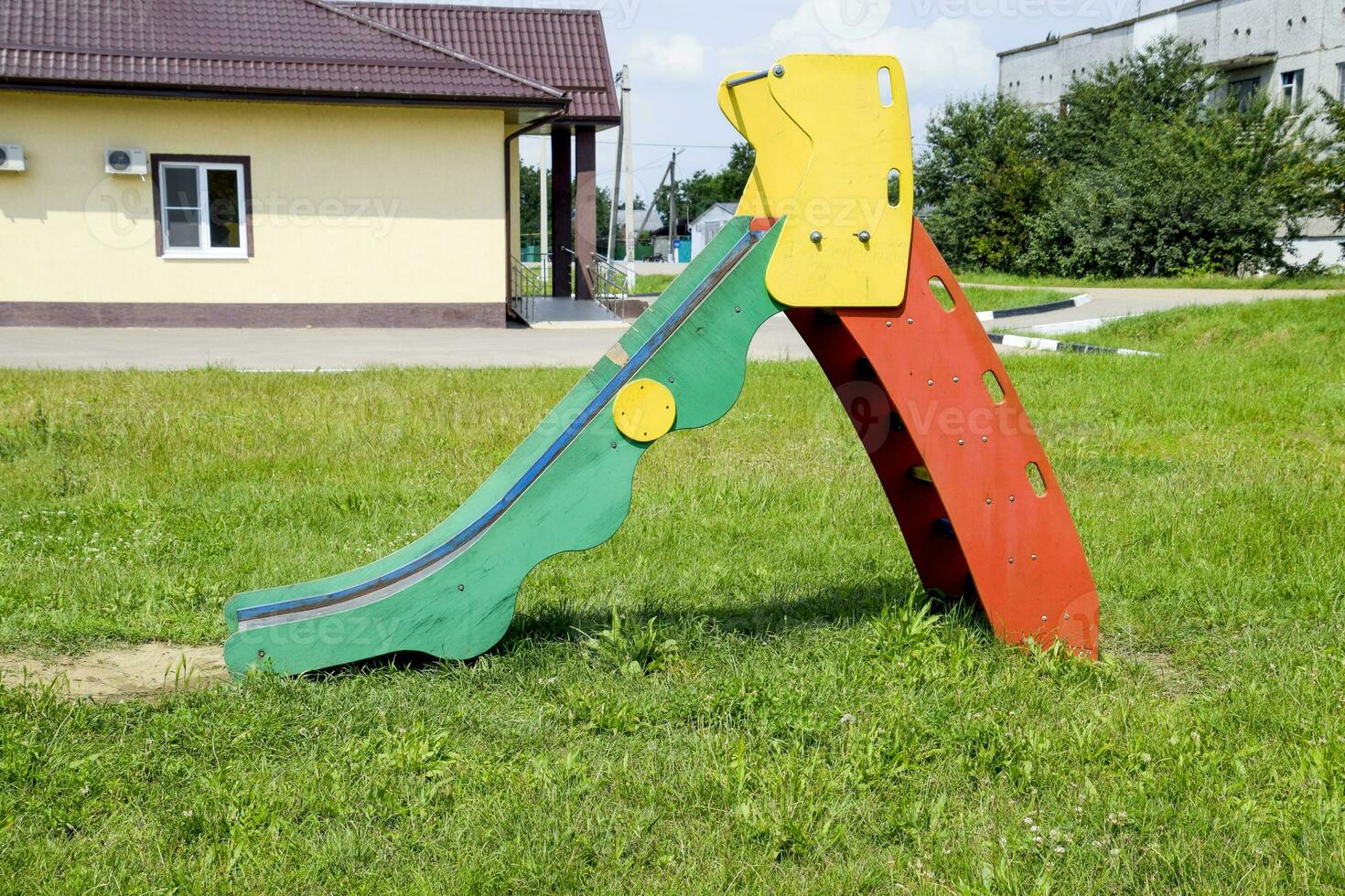 Children's playground. Swing, carousel and slide photo