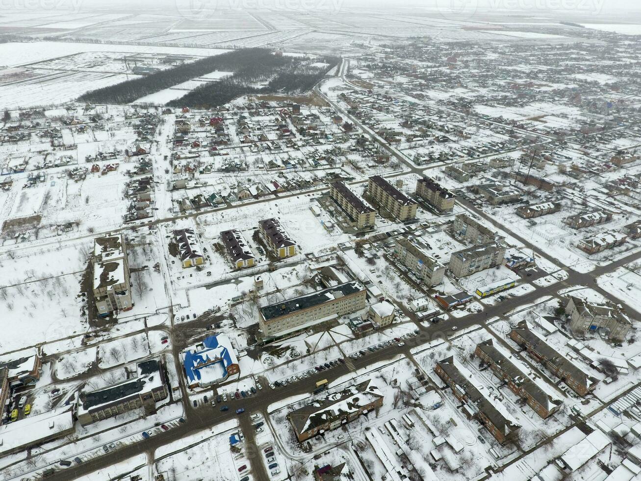 Winter view from the bird's eye view of the village. The streets are covered with snow photo