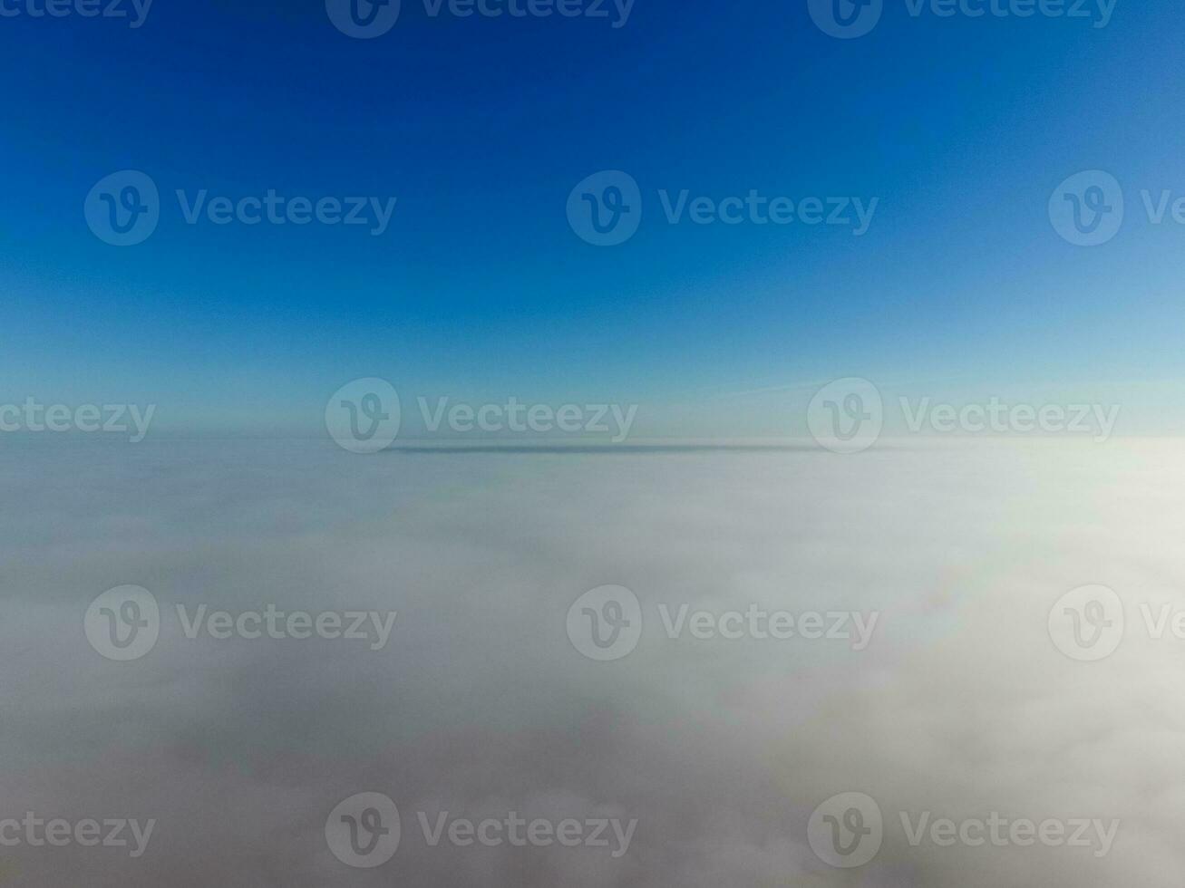 In the skies above the fog. Sunrise over the fog. Clouds near the ground photo