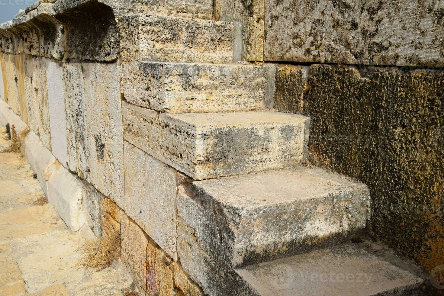 The steps of the amphitheater. Stone limestone and marble. Ancient antique amphitheater in city of Hierapolis in Turkey photo