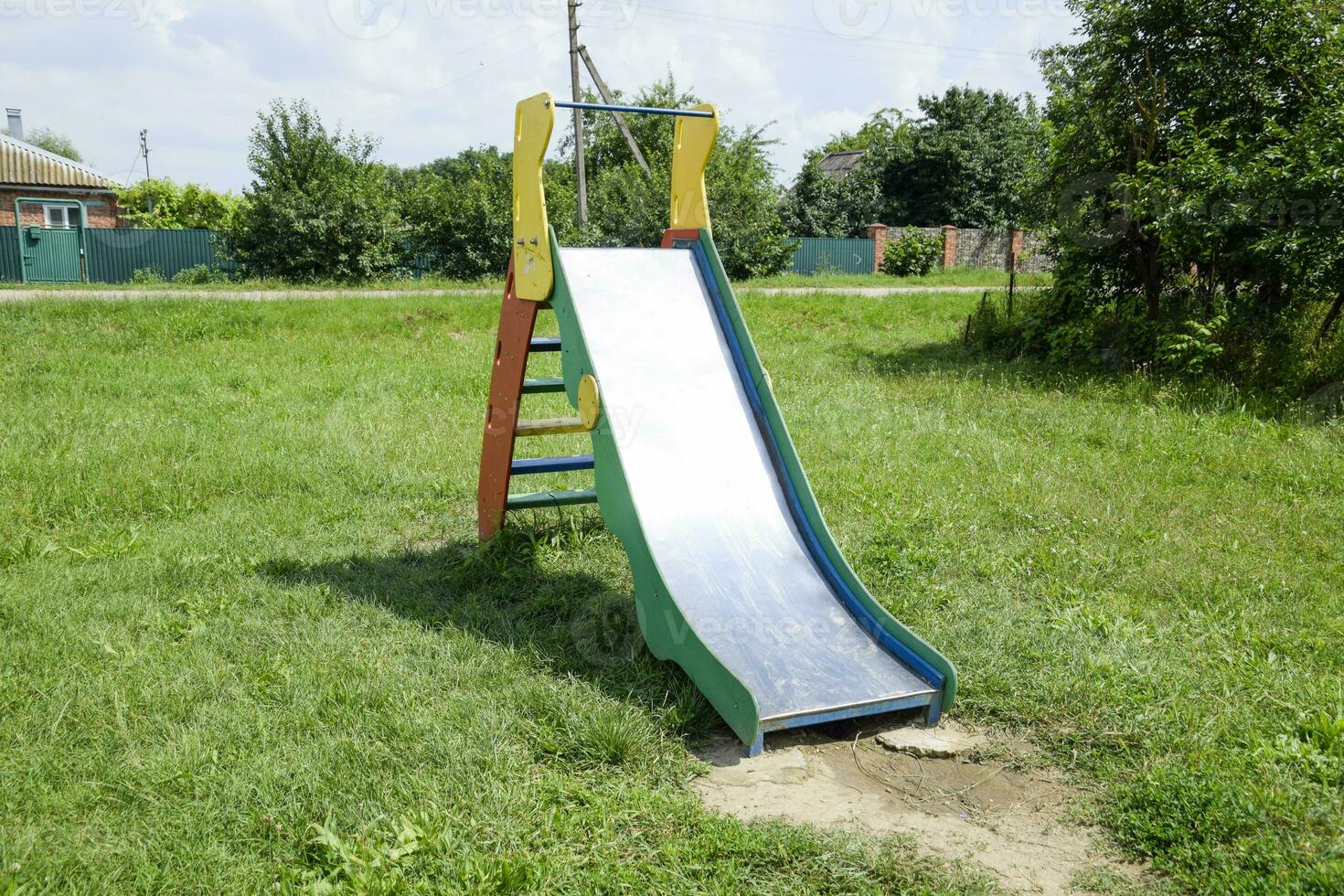 Children's playground. Swing, carousel and slide photo