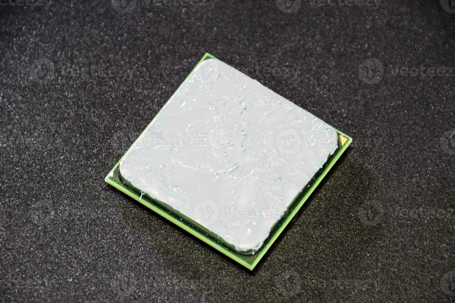 The processor of the computer with the thermal paste applied on it. Details of the computer's system unit. photo