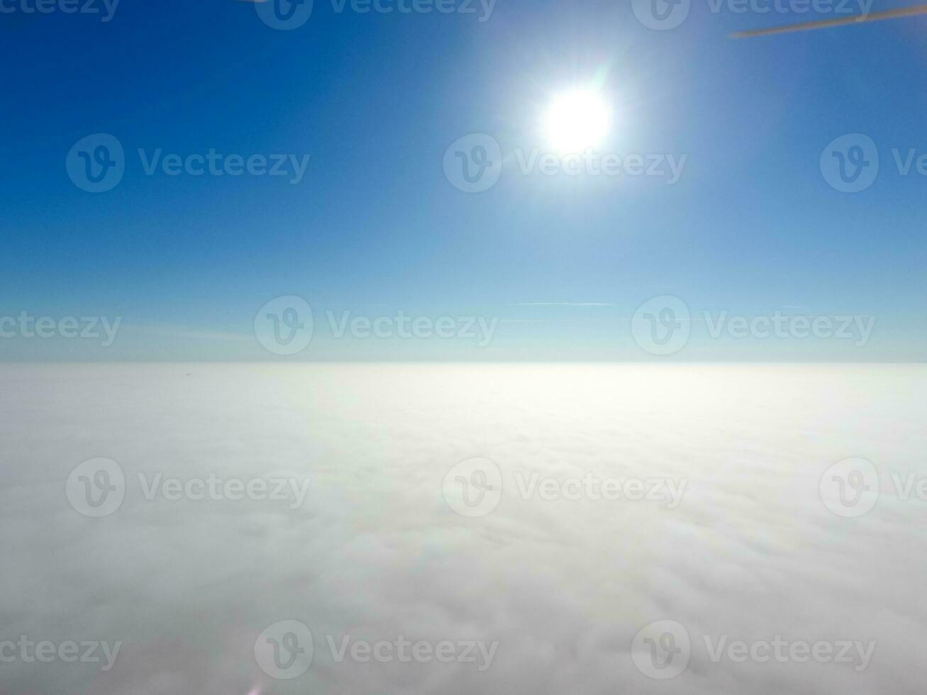 In the skies above the fog. Sunrise over the fog. Clouds near the ground photo