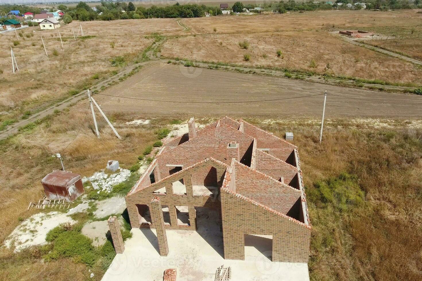 The house is built of red brick. The walls of the house are a top view photo