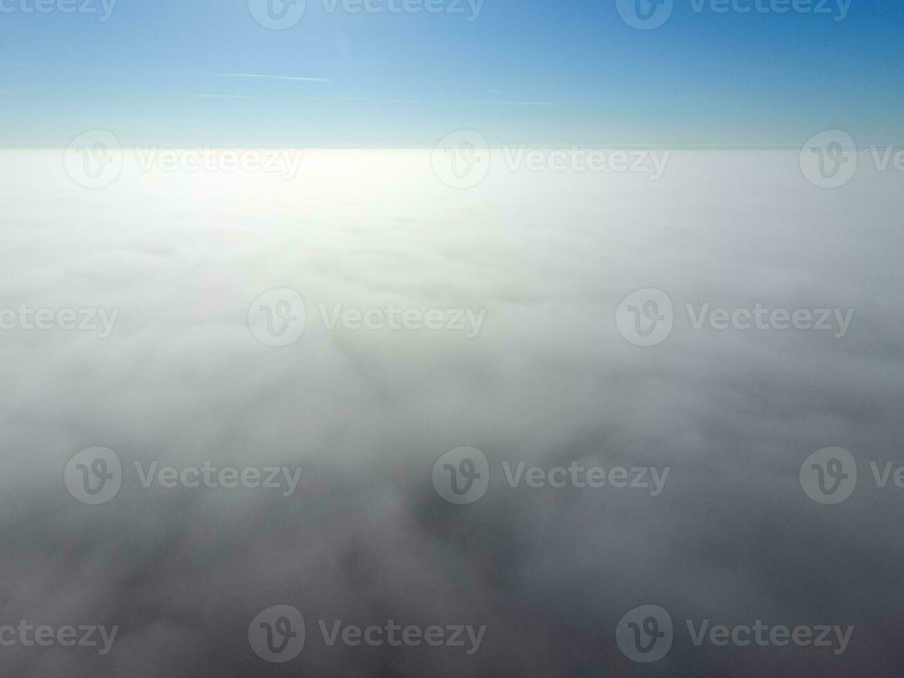 In the skies above the fog. Sunrise over the fog. Clouds near the ground photo