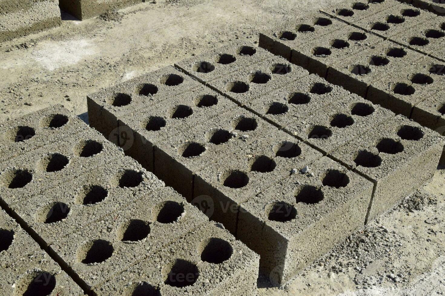 Cinder blocks lie on the ground and dried. on cinder block production plant. photo