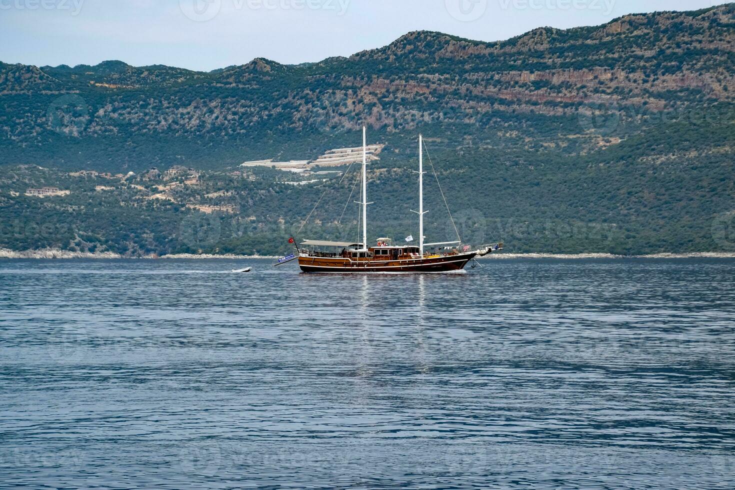 Pleasure yacht in the sea near the island. photo