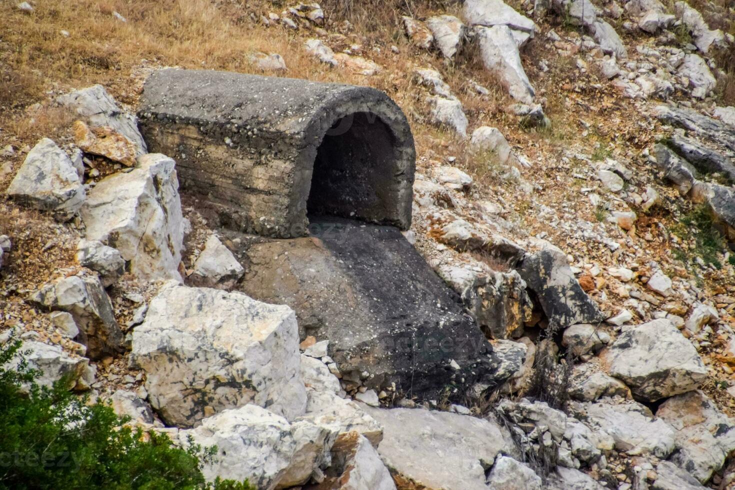 Concrete tunnel for draining sewage under road. photo