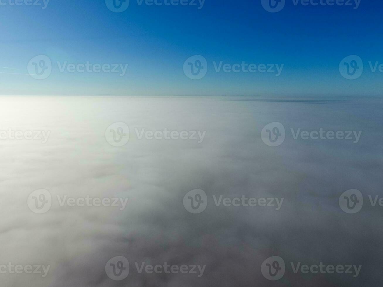In the skies above the fog. Sunrise over the fog. Clouds near the ground photo