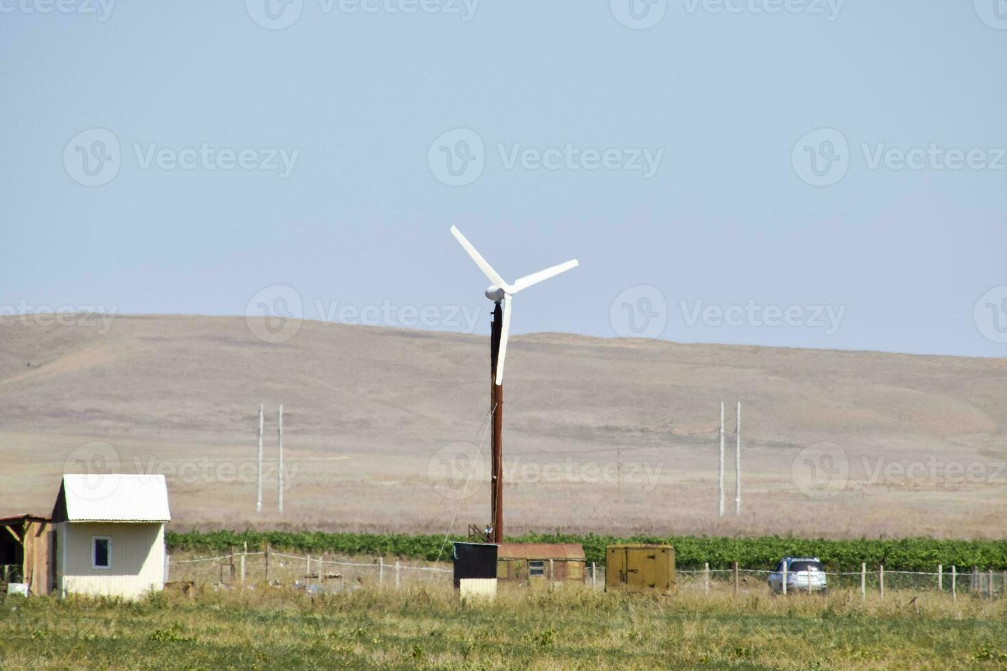 Wind power plant. A wind turbine in the field for generating electricity. photo