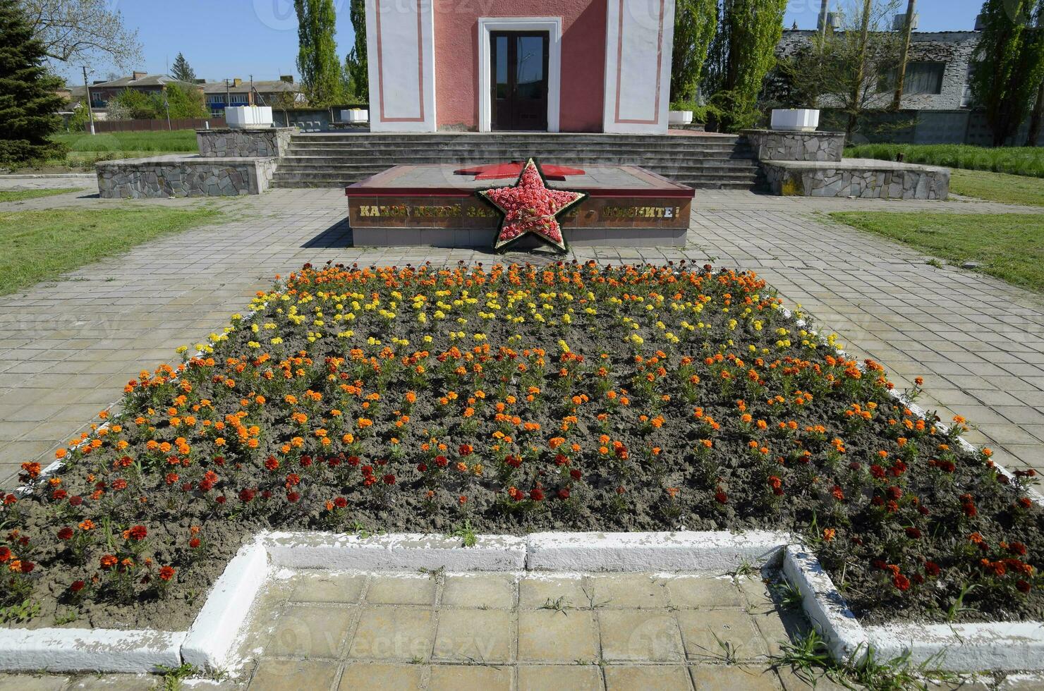 Chapel and star with eternal fire near the house of culture near the central square in Oktyabrsky settlement. photo