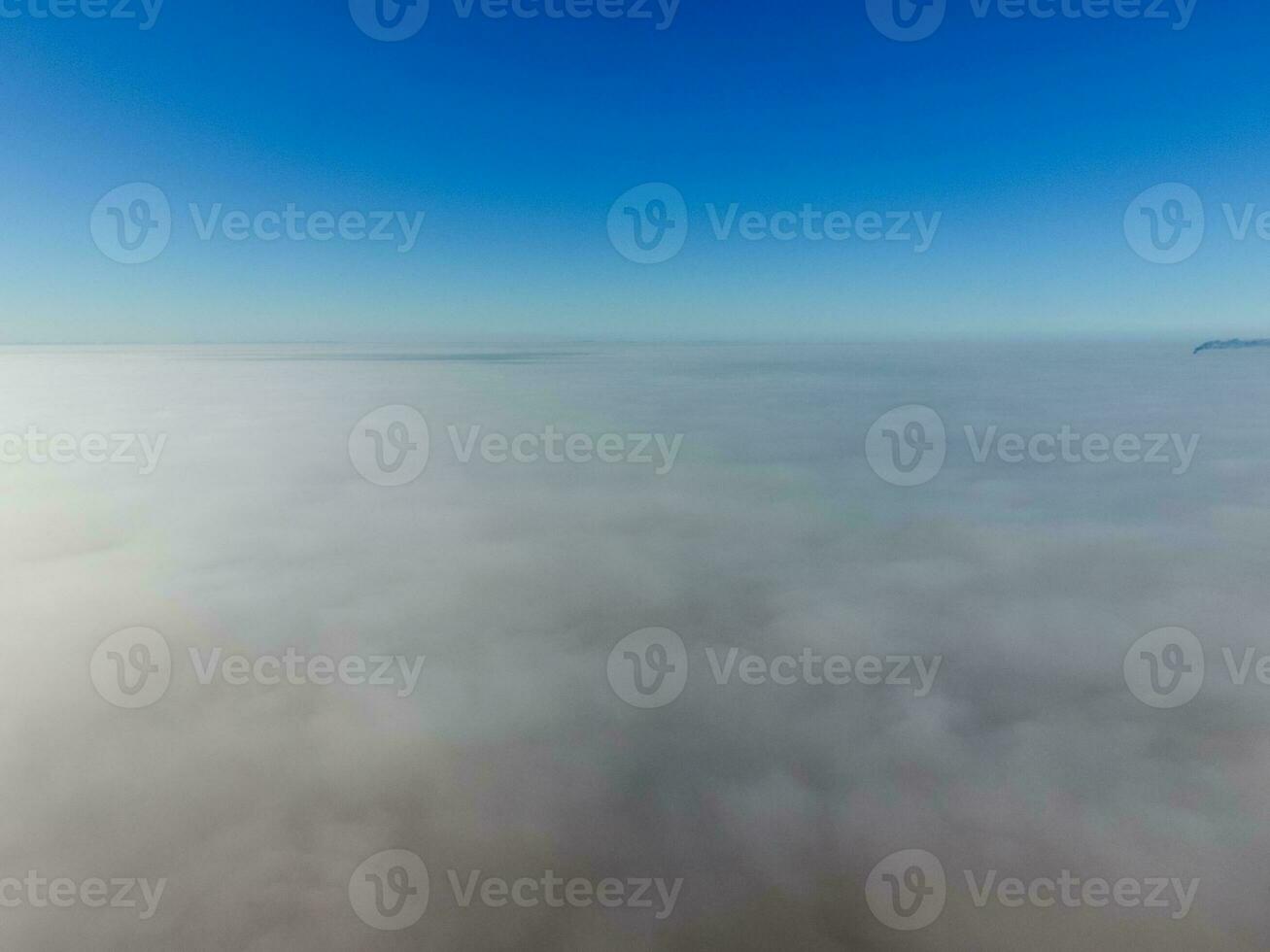 In the skies above the fog. Sunrise over the fog. Clouds near the ground photo