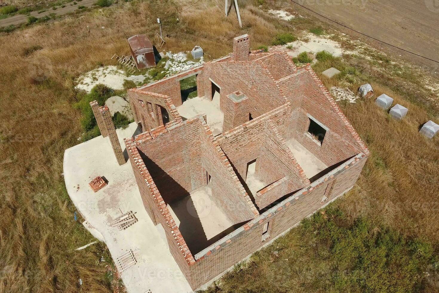 The house is built of red brick. The walls of the house are a top view photo